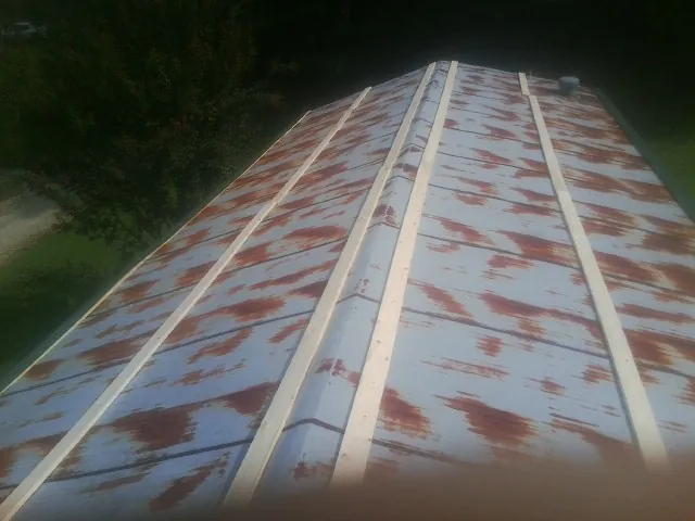Rusted metal roof panels with new wood purlins before replacement — Storm Damage Roof Repair in Fort Lee by Roofing Brothers