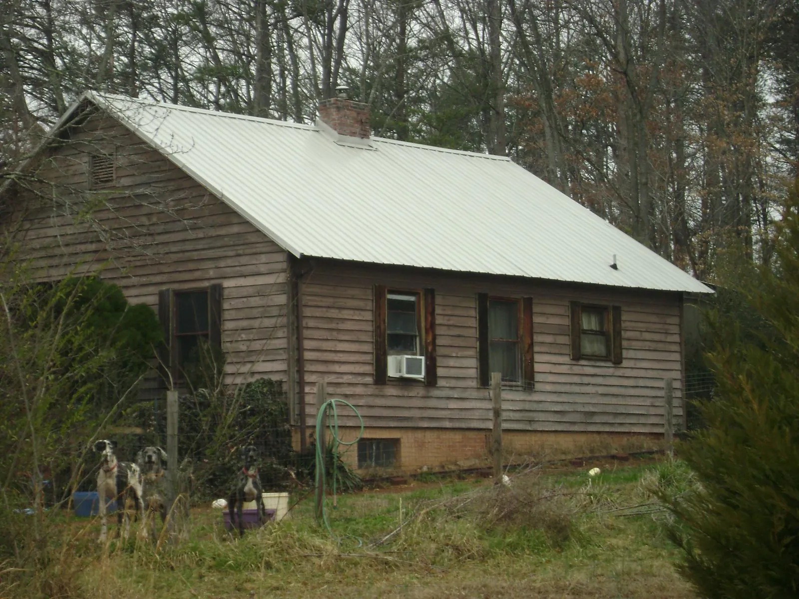 White metal roof on an old wood sided farmhouse, from a Metal Roof Installation job in Fort Lee